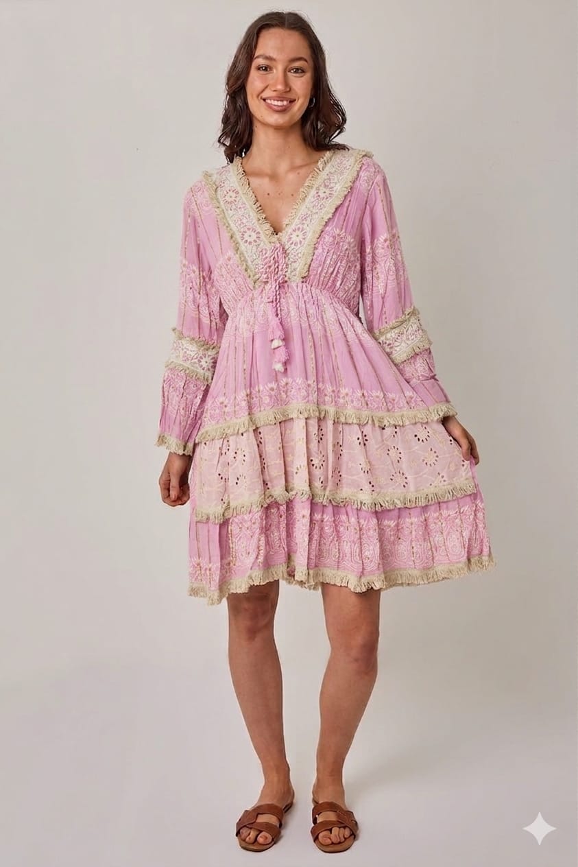 Woman wearing a pink lace dress on a white background
