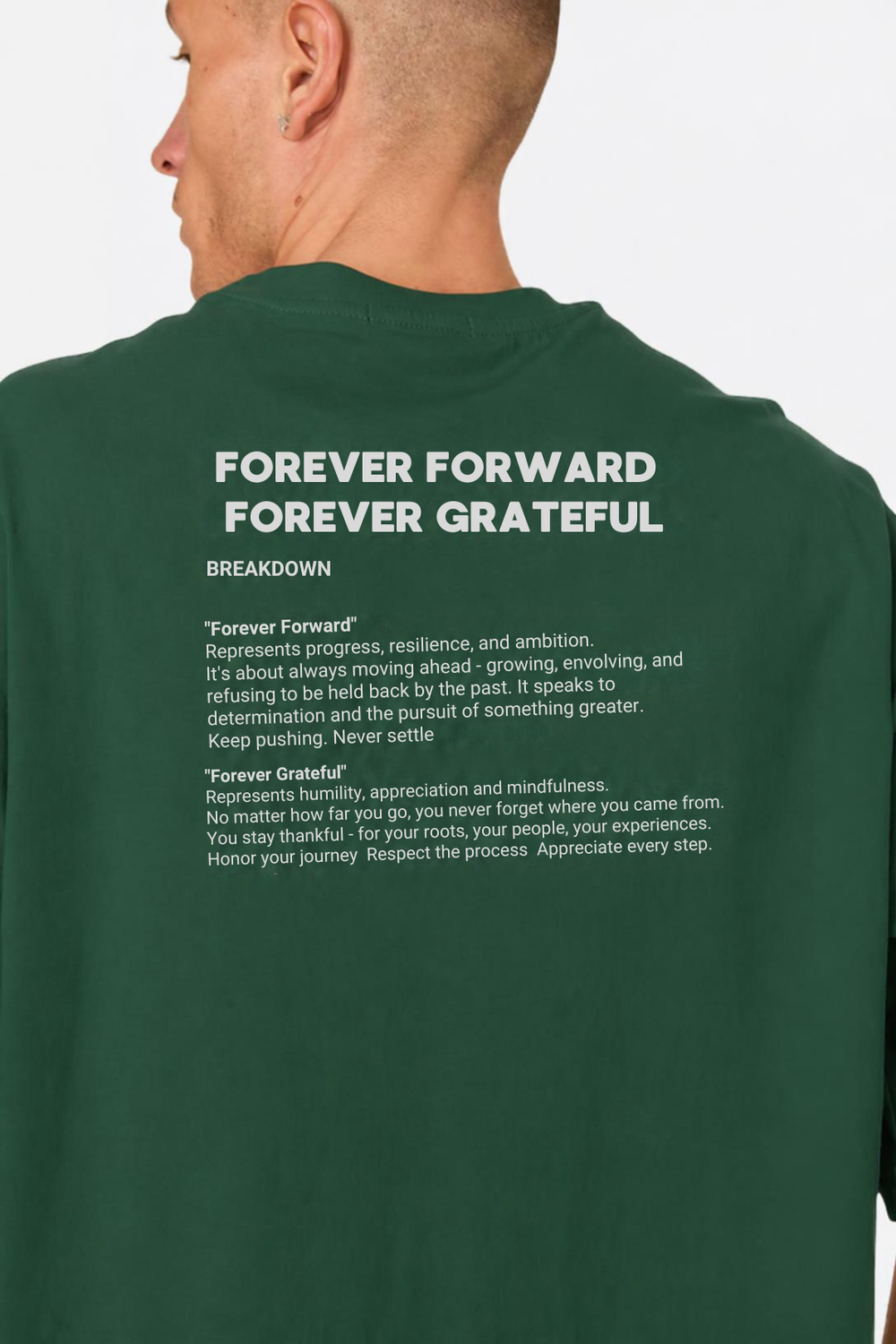 A man shown from the back wearing a dark green long-sleeve t-shirt with white printed motivational text that reads 'FOREVER FORWARD FOREVER GRATEFUL' and definitions underneath.