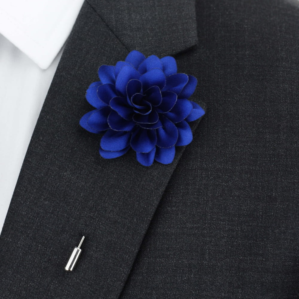 Blue lapel pin flower on grey suit