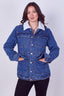 A woman modeling a blue denim jacket with a white sherpa collar, standing against a light gray studio background.