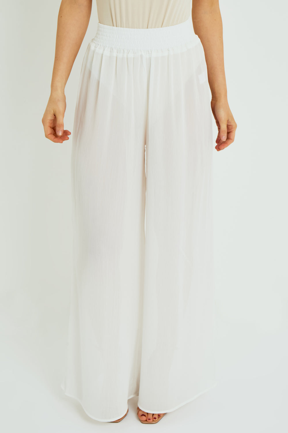 White wide-leg pants worn by a person on a white background