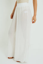 White wide-leg pants worn by a person on a white background