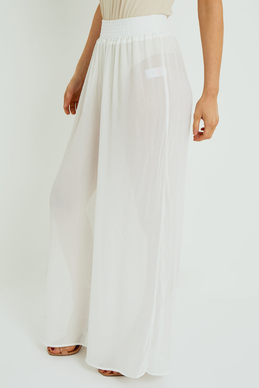 White wide-leg pants worn by a person on a white background