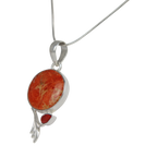 This beautiful orange colour round Sponge Coral pendant is set in an open back bazel.