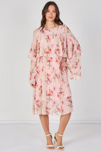 Woman wearing a pink floral dress against a white background