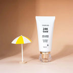 Ammuri Skincare 24K Gold collagen face mask peel off tube with a small yellow and white umbrella
