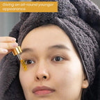 Ammuri Skincare 24K gold serum for dark circles being applied to the under-eye area for rejuvenation