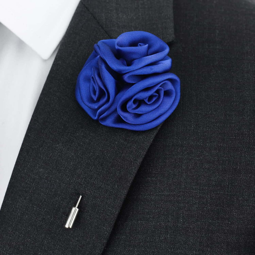 Blue rose lapel pin on a black suit jacket