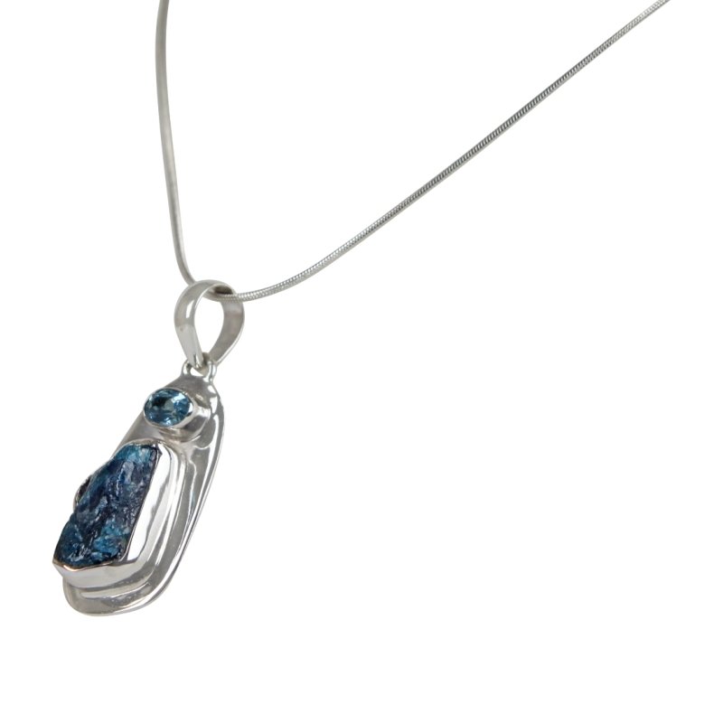 A beautiful rough Neon Apatite pendant accent with a Blue Topaz and elegantly hand set in Sterling Silver bazel. Secondary image